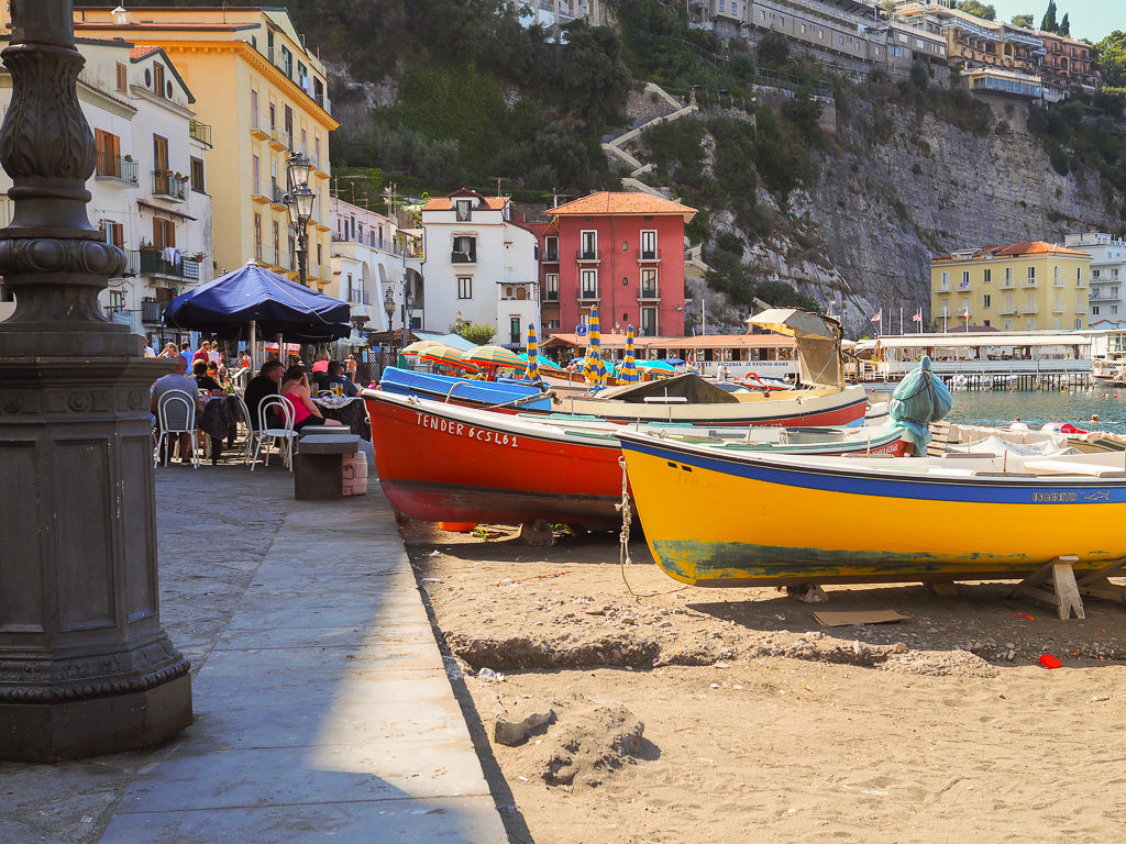 Colourful boats pulled onto sand in harbour
