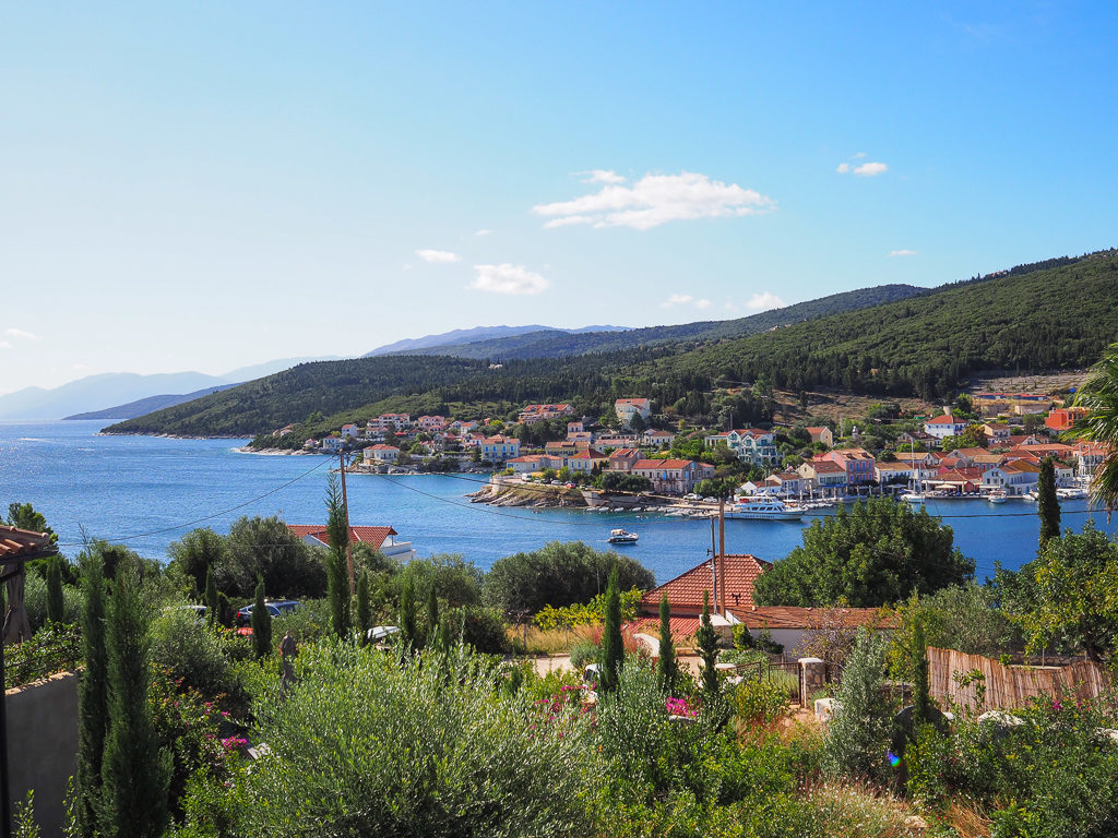 Fiskardo Kefalonia. View of the harbour of Fiscardo village from the balcony of a luxury Greek villa. Copyright ©2020 mapandfamily.com