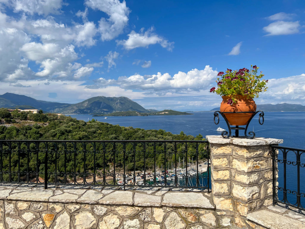 View from a belvedere with railings and urn on Meganisi a small island off Lefkada, Greece. Copyright@ 2022 mapandfamily.com