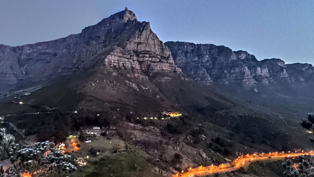 Twilight on mountain range and lights running along roads. Copyright@2024 reserved to photographer via mapandfamily.com 