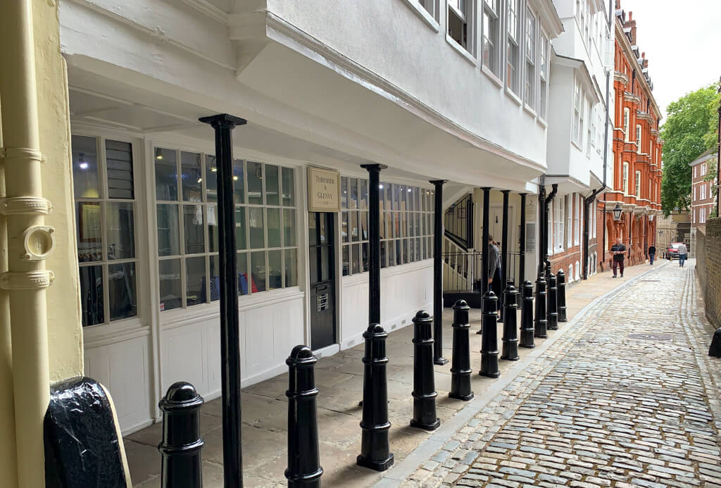 A peaceful cobbled street with period buildings in black and white and red brick off Holborn. Copyright 2024@mapandfamily.com 