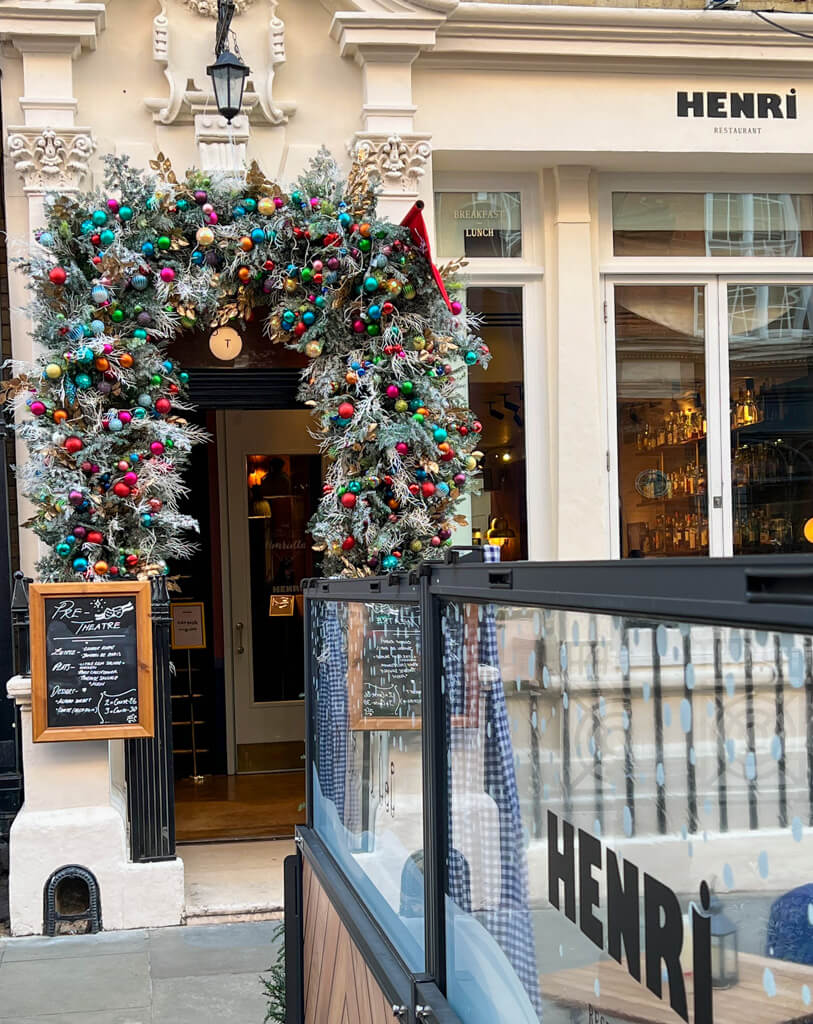 Archway of decorations leading into Henri restaurant. Copyright@2024 mapandfamily.com