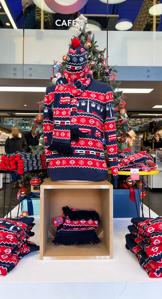 Christmas jumpers with transport theme piled up in shop. Copyright@2024 mapandfamily.com
