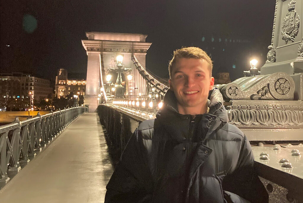 Young man standing on illluminated road bridge at night. Copyright@2025reserved to photographer via MapandFamily