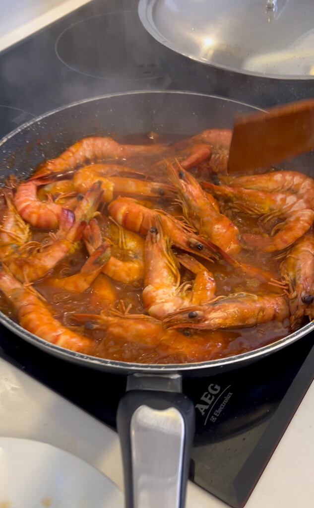 Pan of delicious looking tomatoe'y prawns in pan on hob in kitchen of Villa Bliss. Copyright@2025NancyRoberts